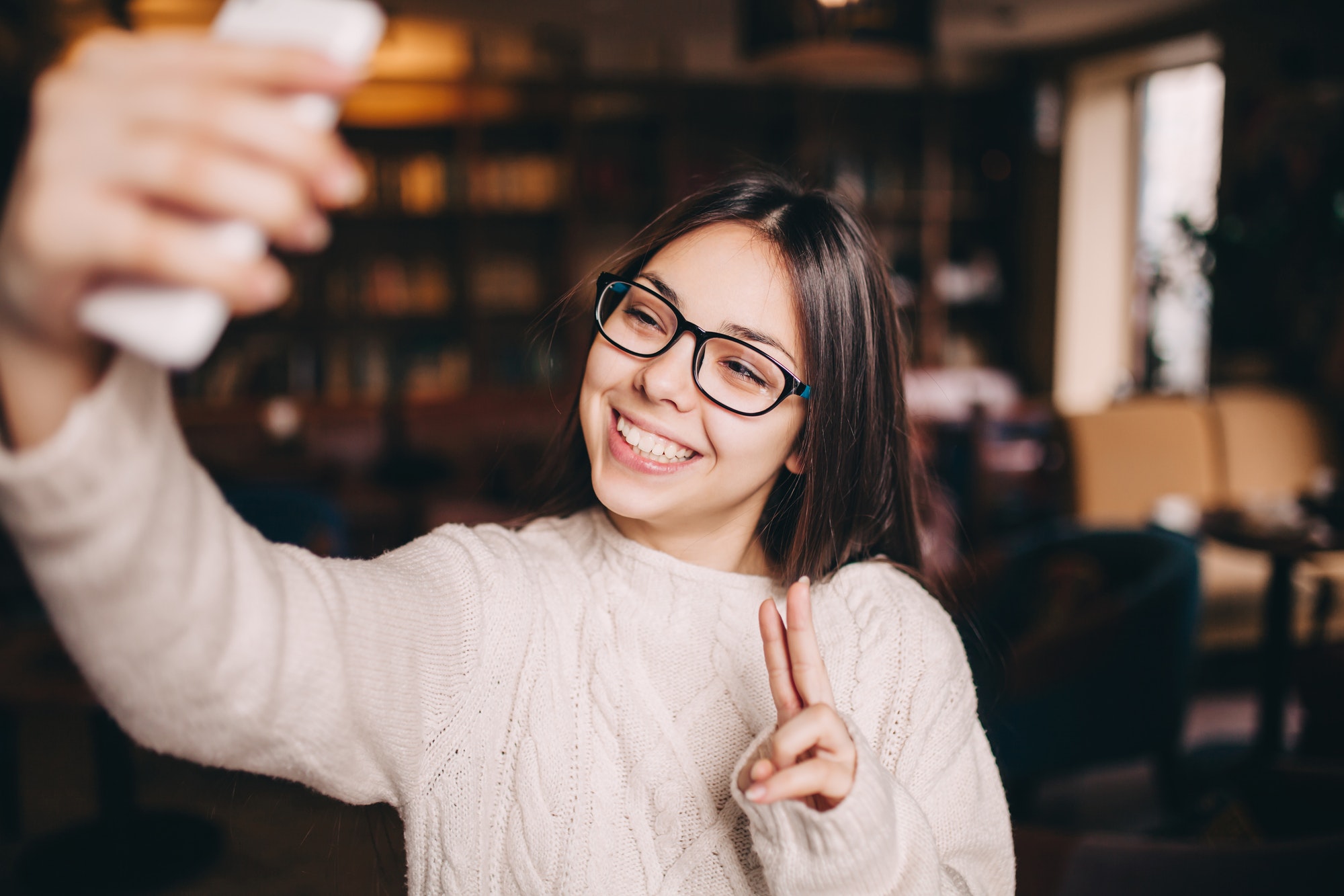 Cute girl face in sunglasses is making selfie photo.